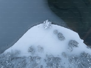 an aerial view of snow covered ground and water