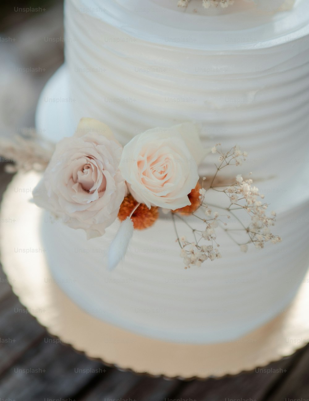 a close up of a wedding cake with flowers on it