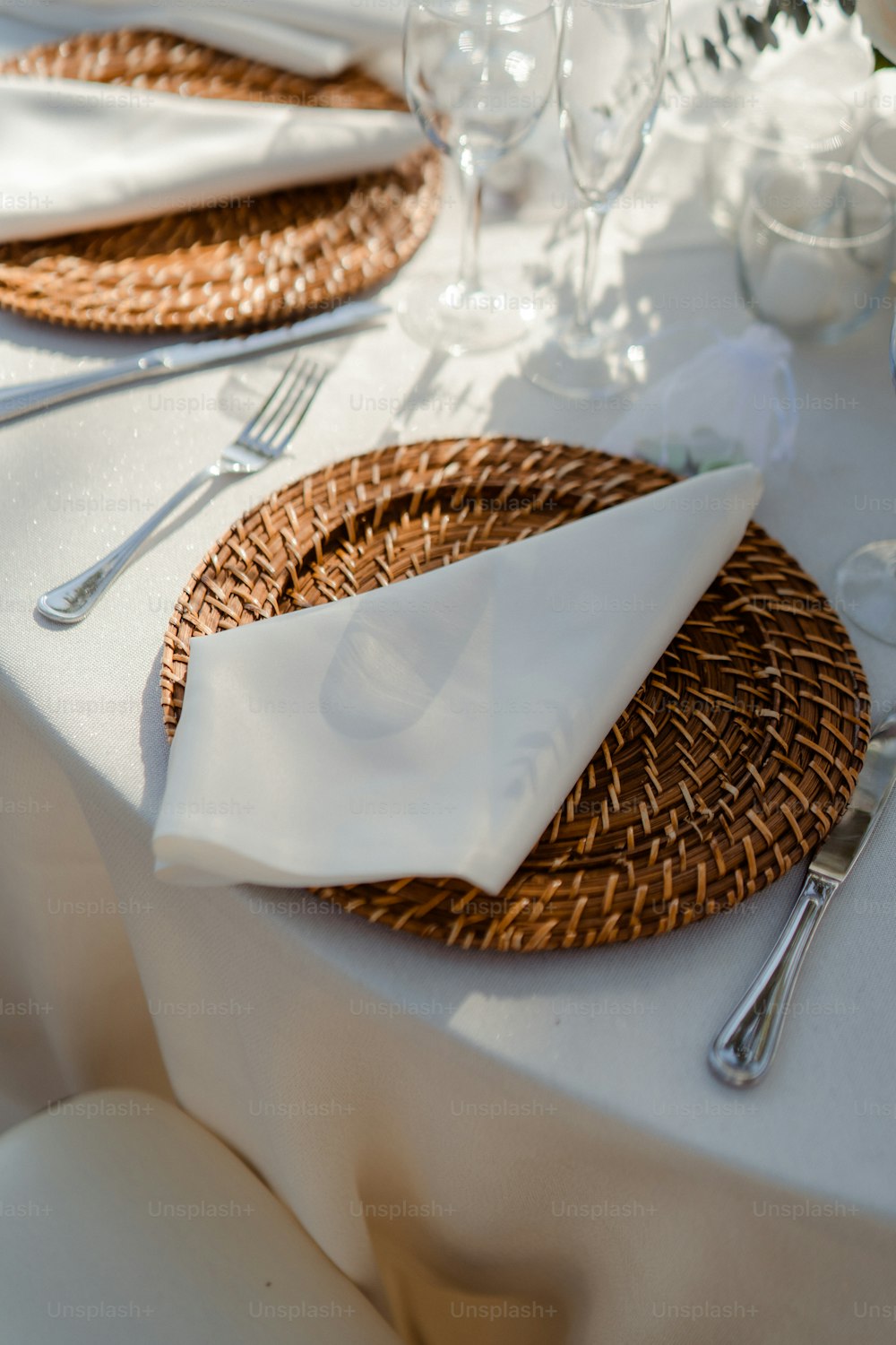 a table with a white table cloth and place settings