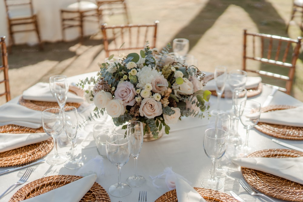 a table set with place settings and flowers