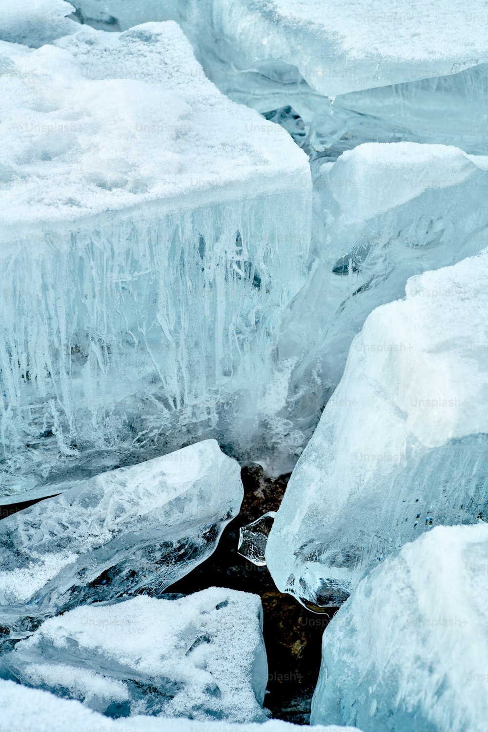 a polar bear sitting on ice blocks in the water