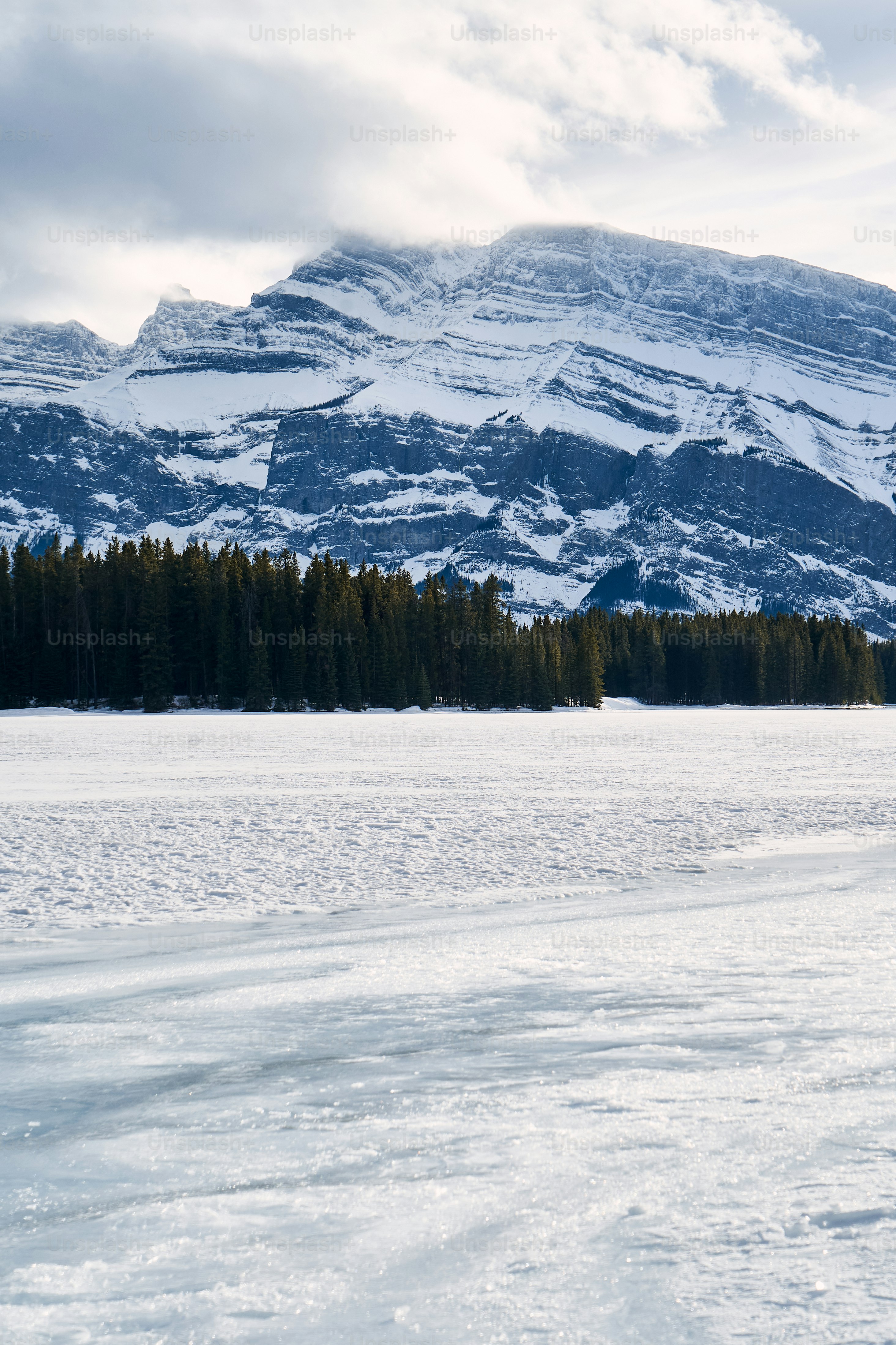 a man riding skis down a snow covered slope