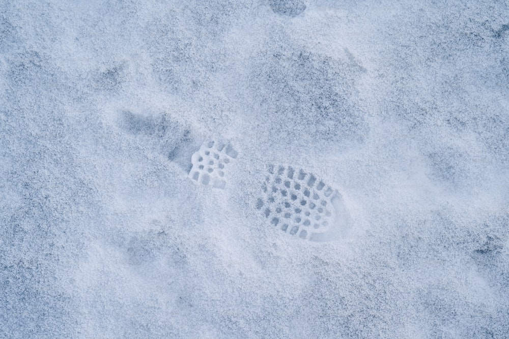 a person's foot prints in the snow