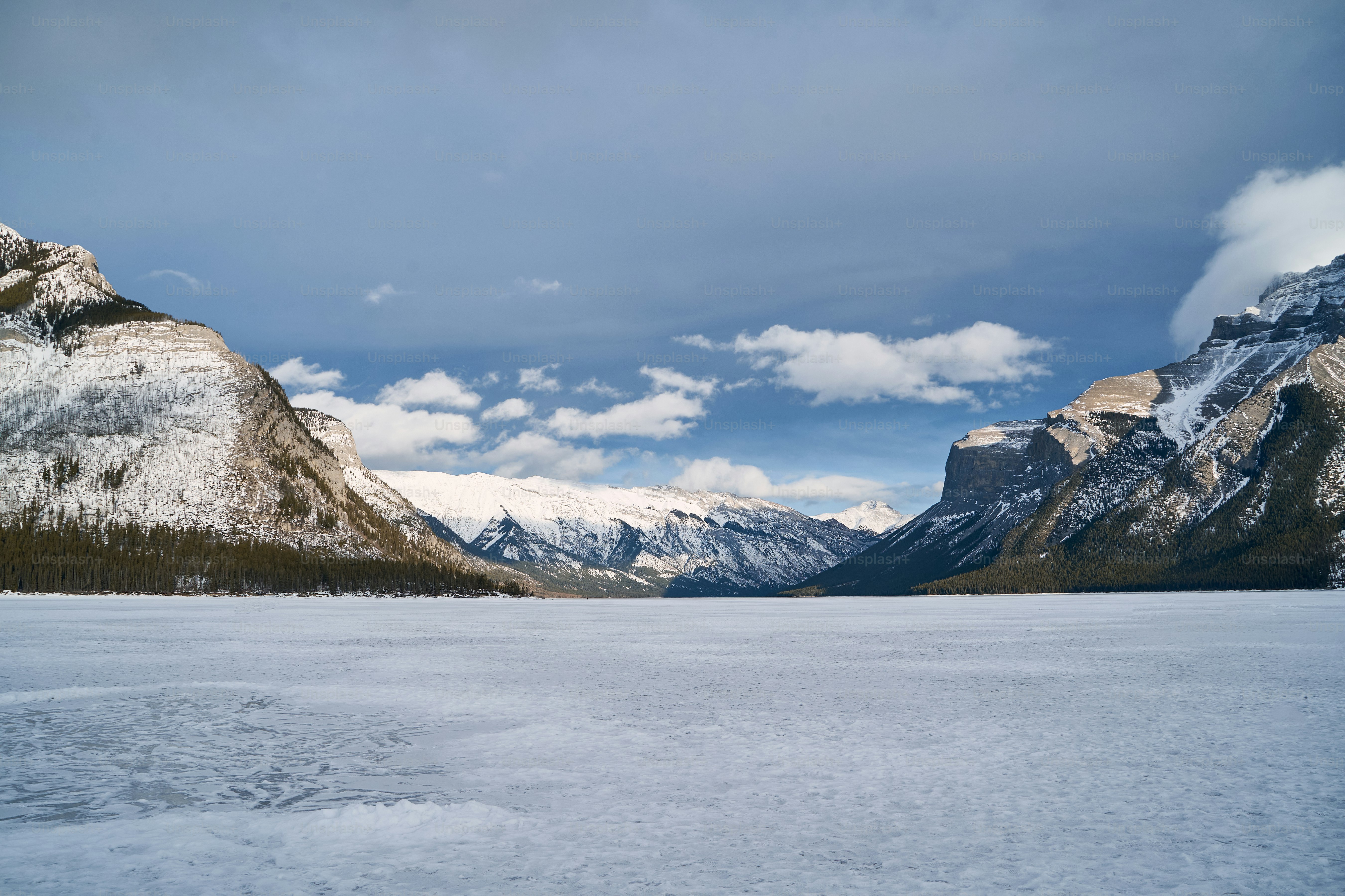 a large body of water surrounded by snow covered mountains