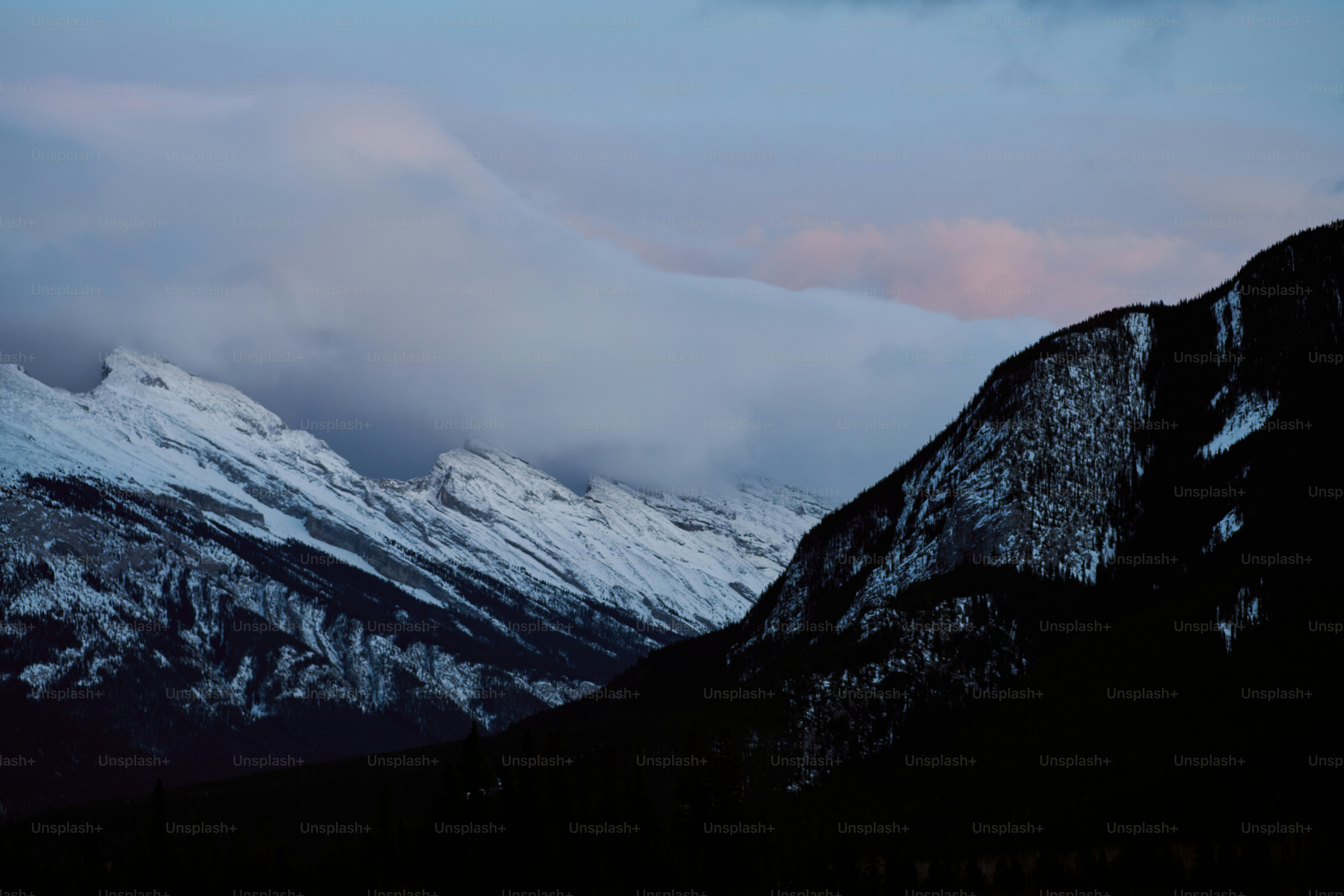 a mountain range with snow covered mountains in the background