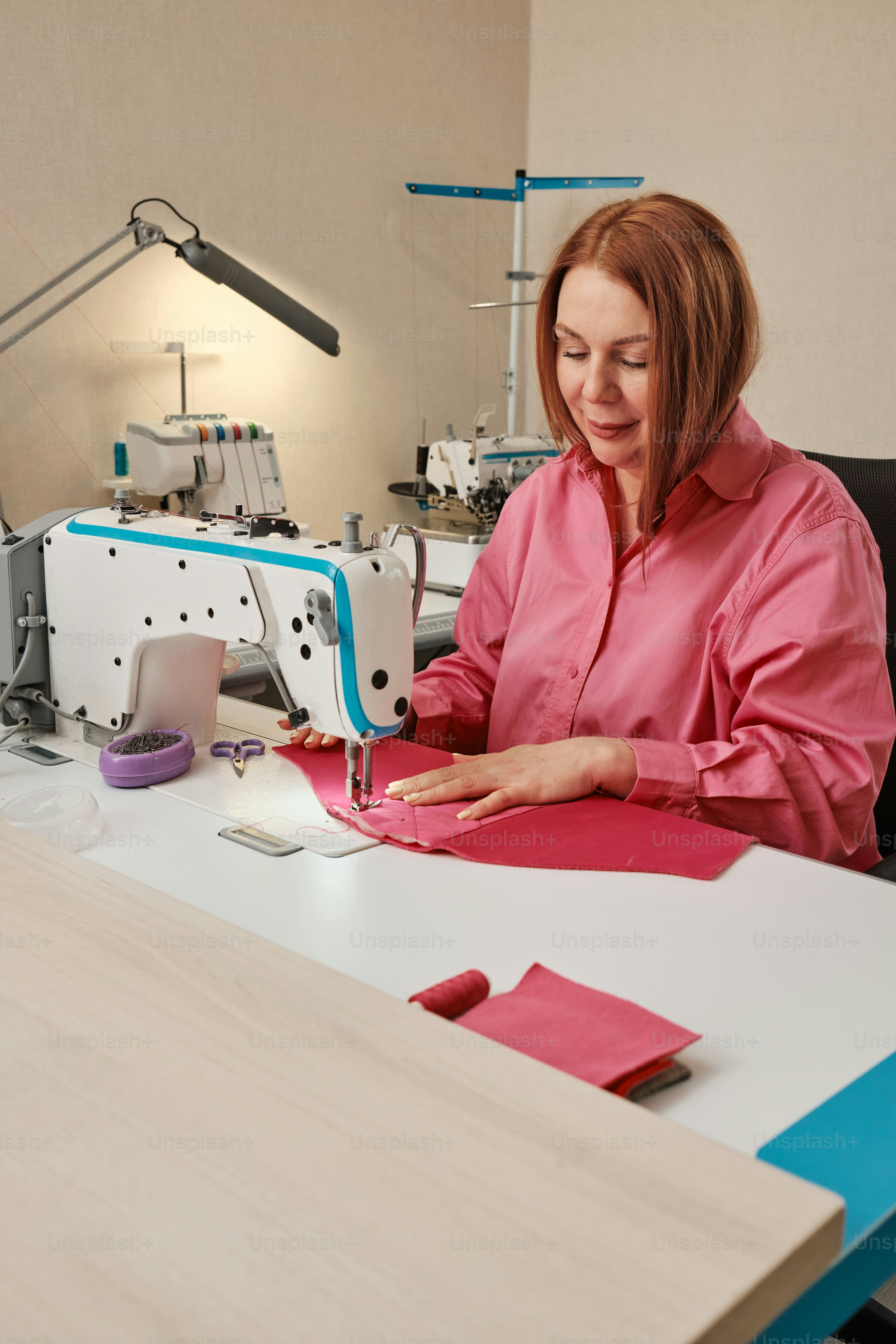 A woman is working on a sewing machine photo – Woman Image on Unsplash