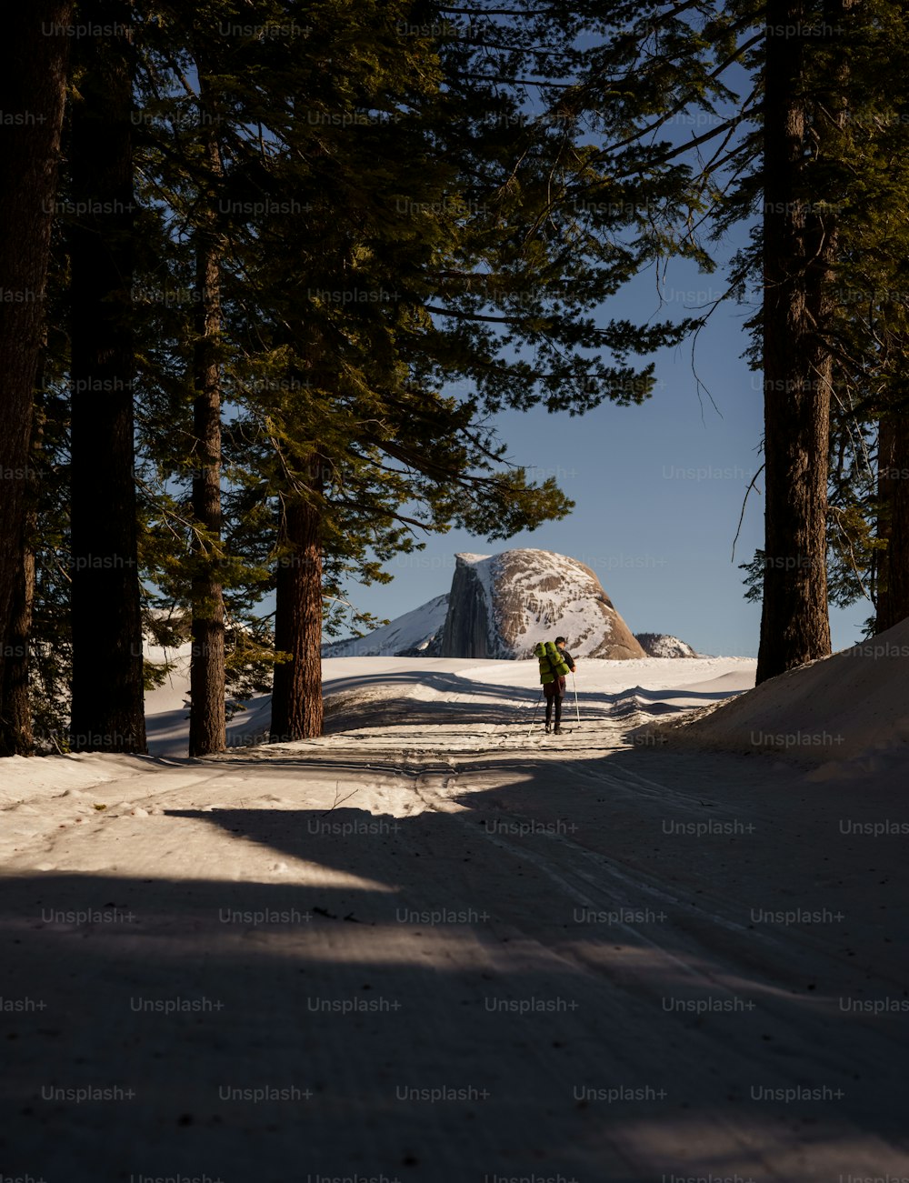 a person walking down a snow covered road