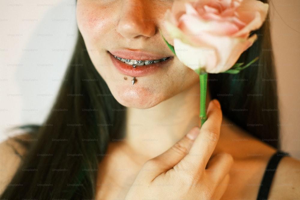 uma mulher segurando uma flor em sua mão direita