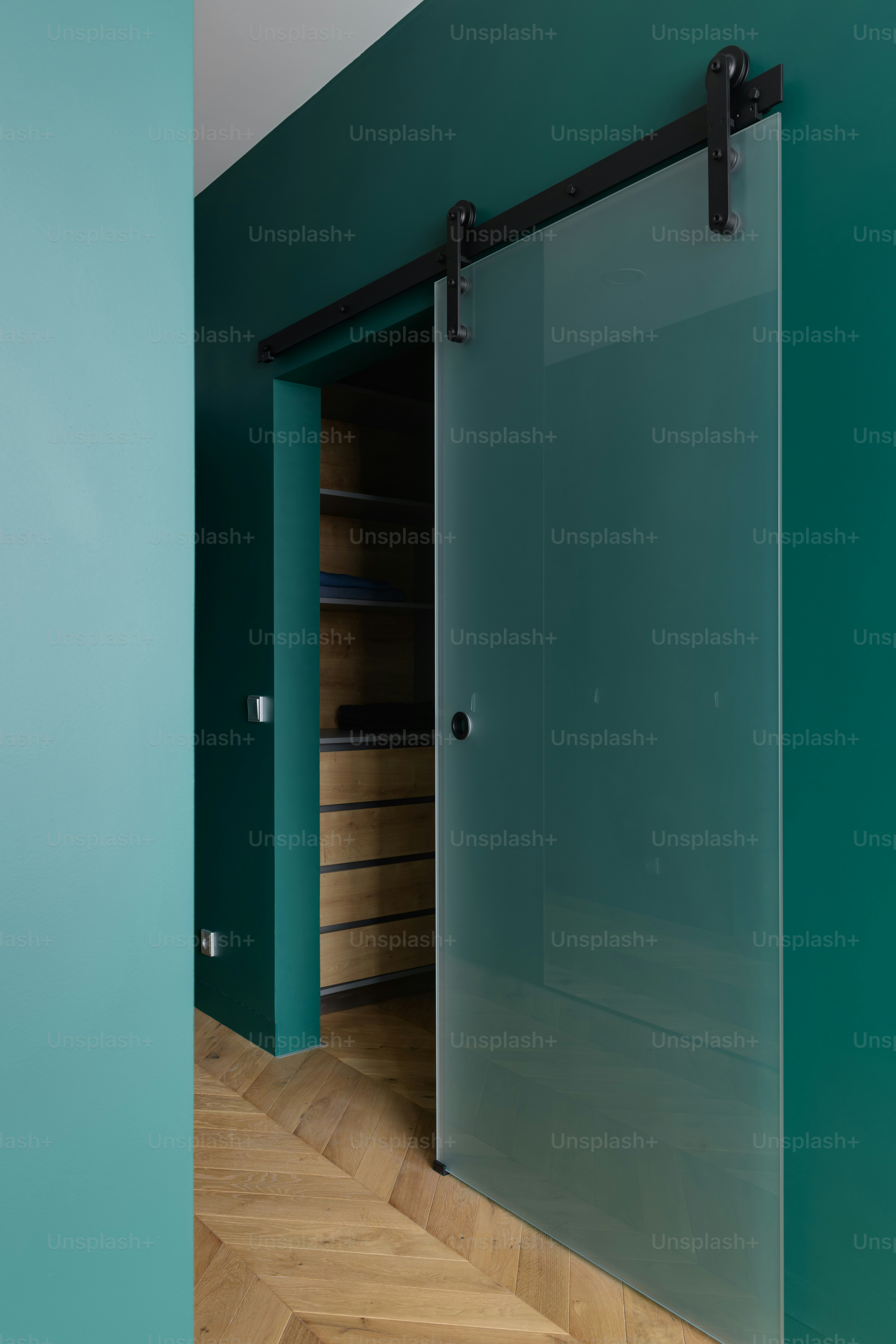 a green room with a sliding glass door