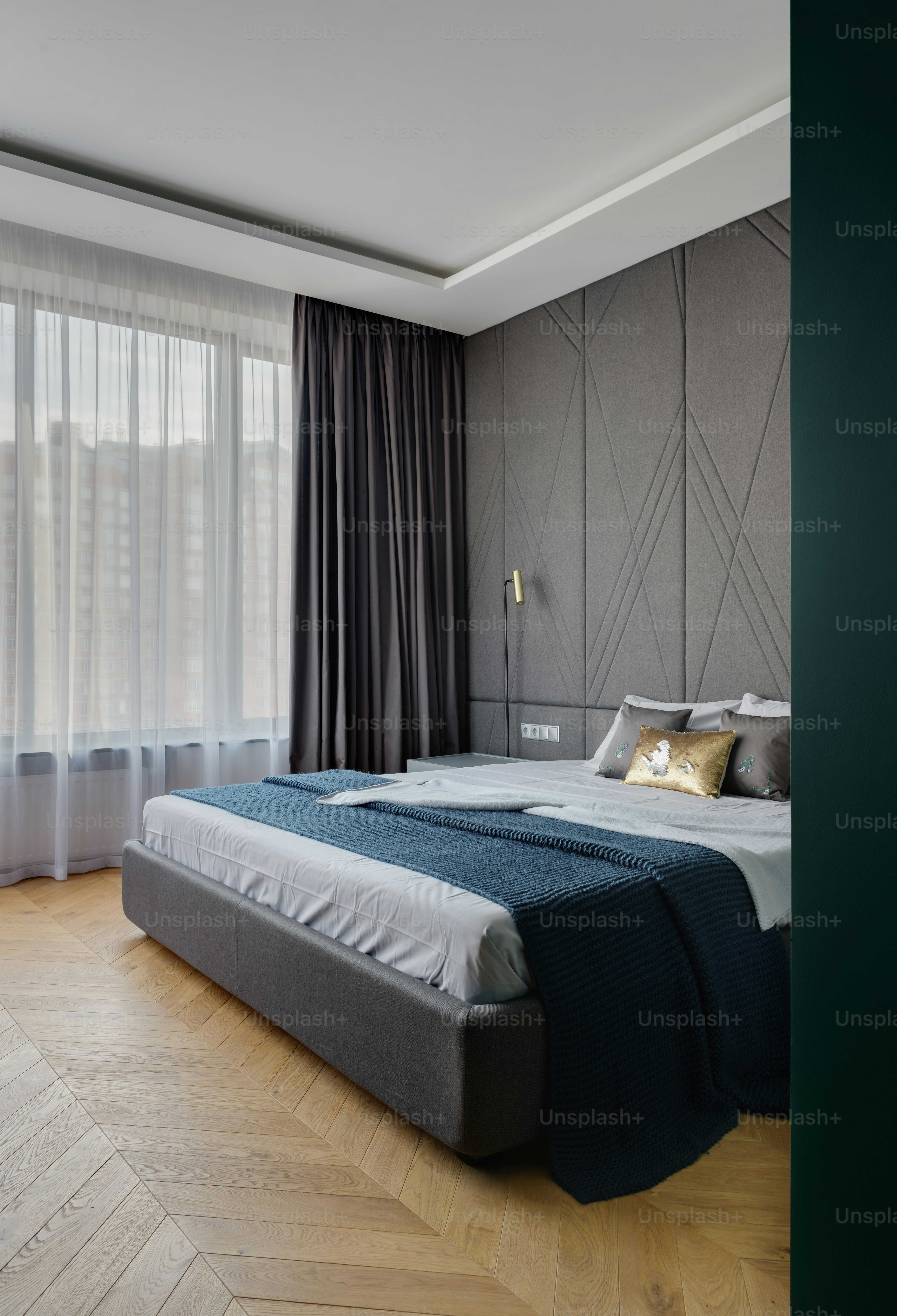 a bedroom with a large bed and a large window