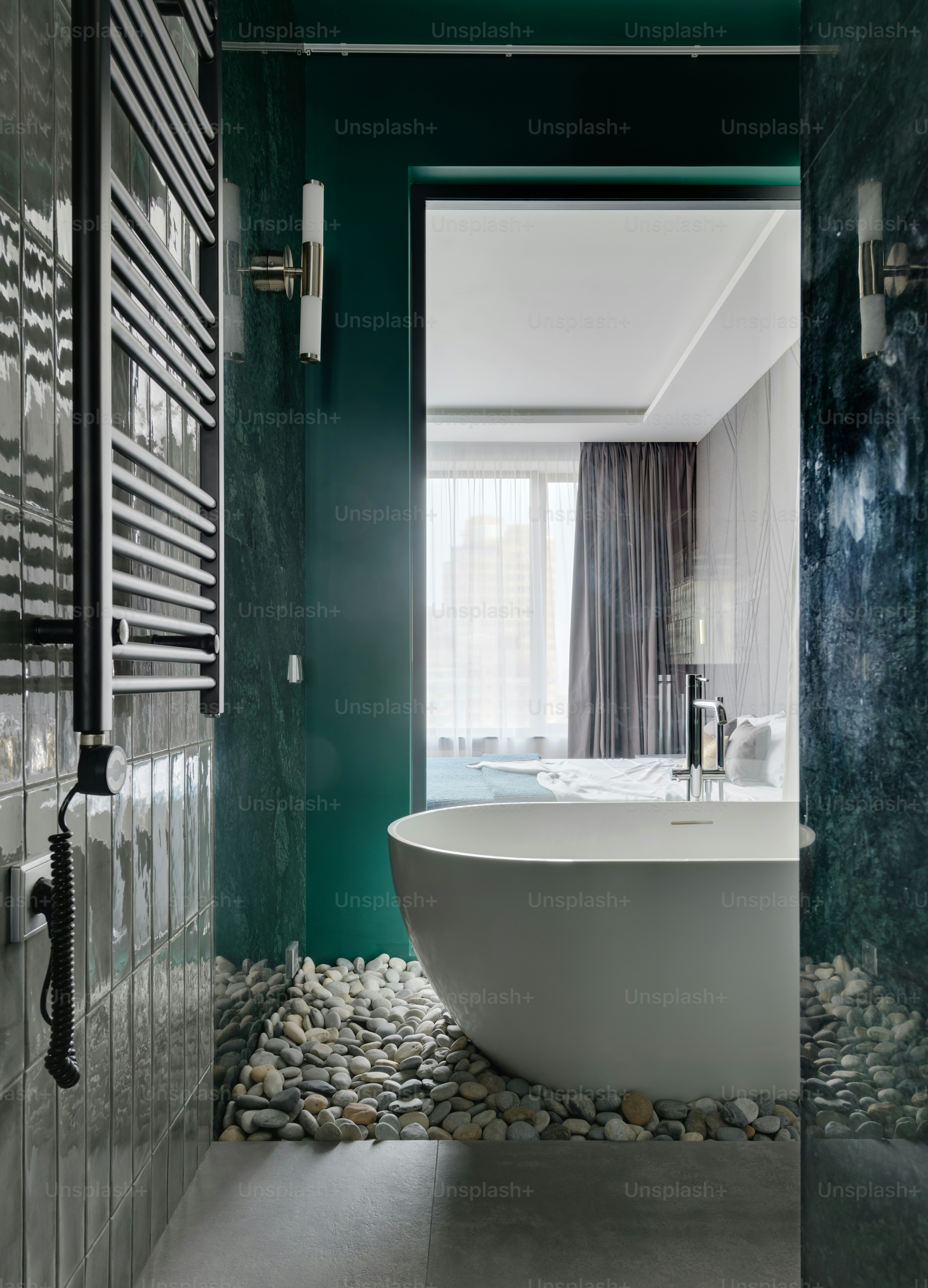 a bathroom with green walls and a white bathtub