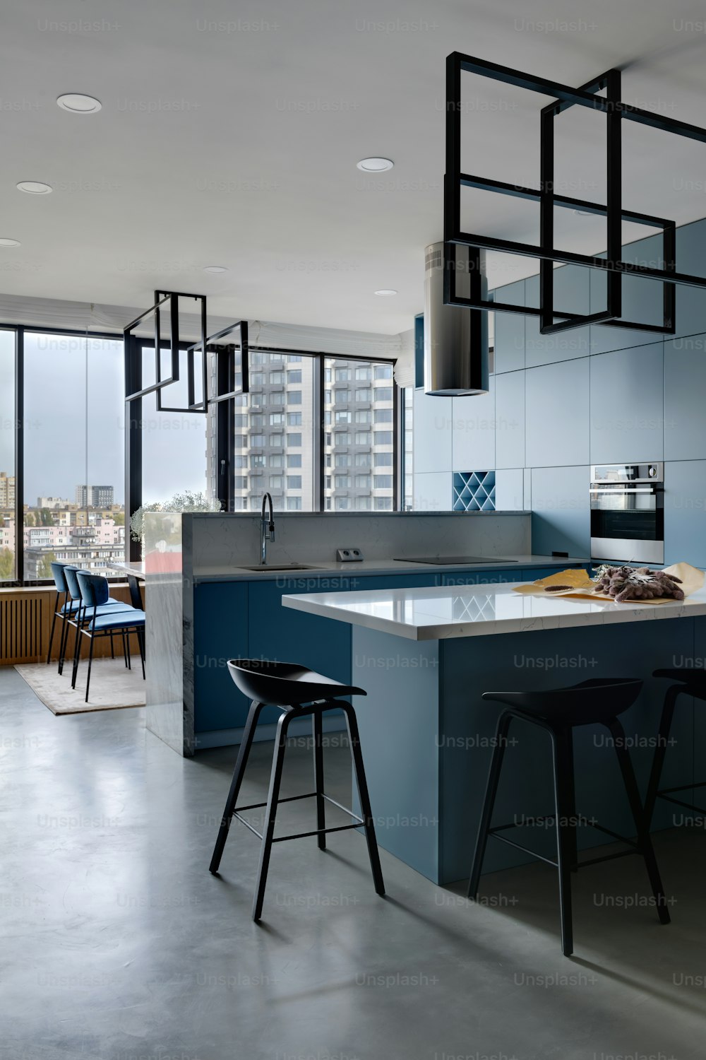 a kitchen with blue cabinets and counter tops