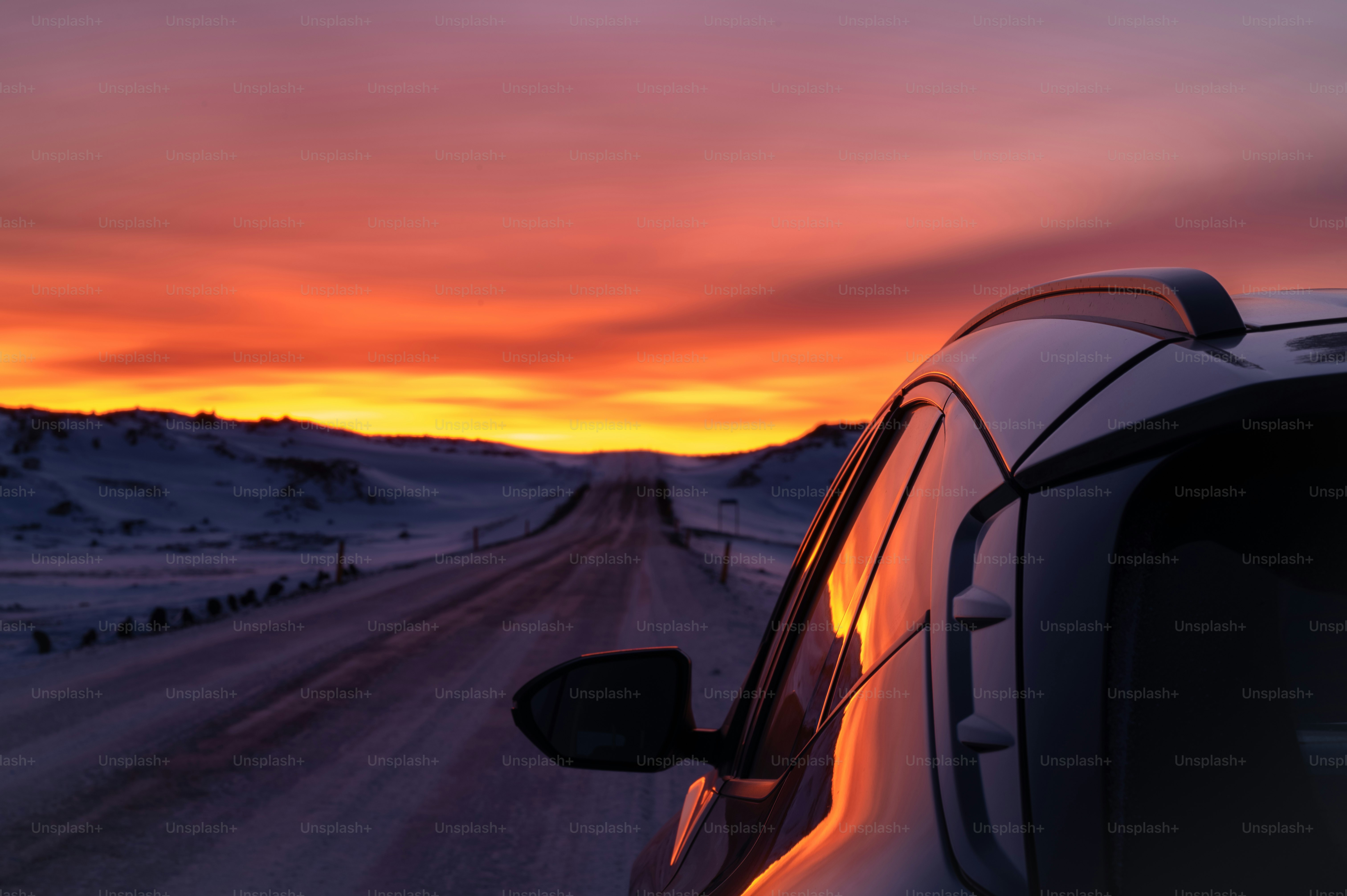 a car parked on the side of a snowy road