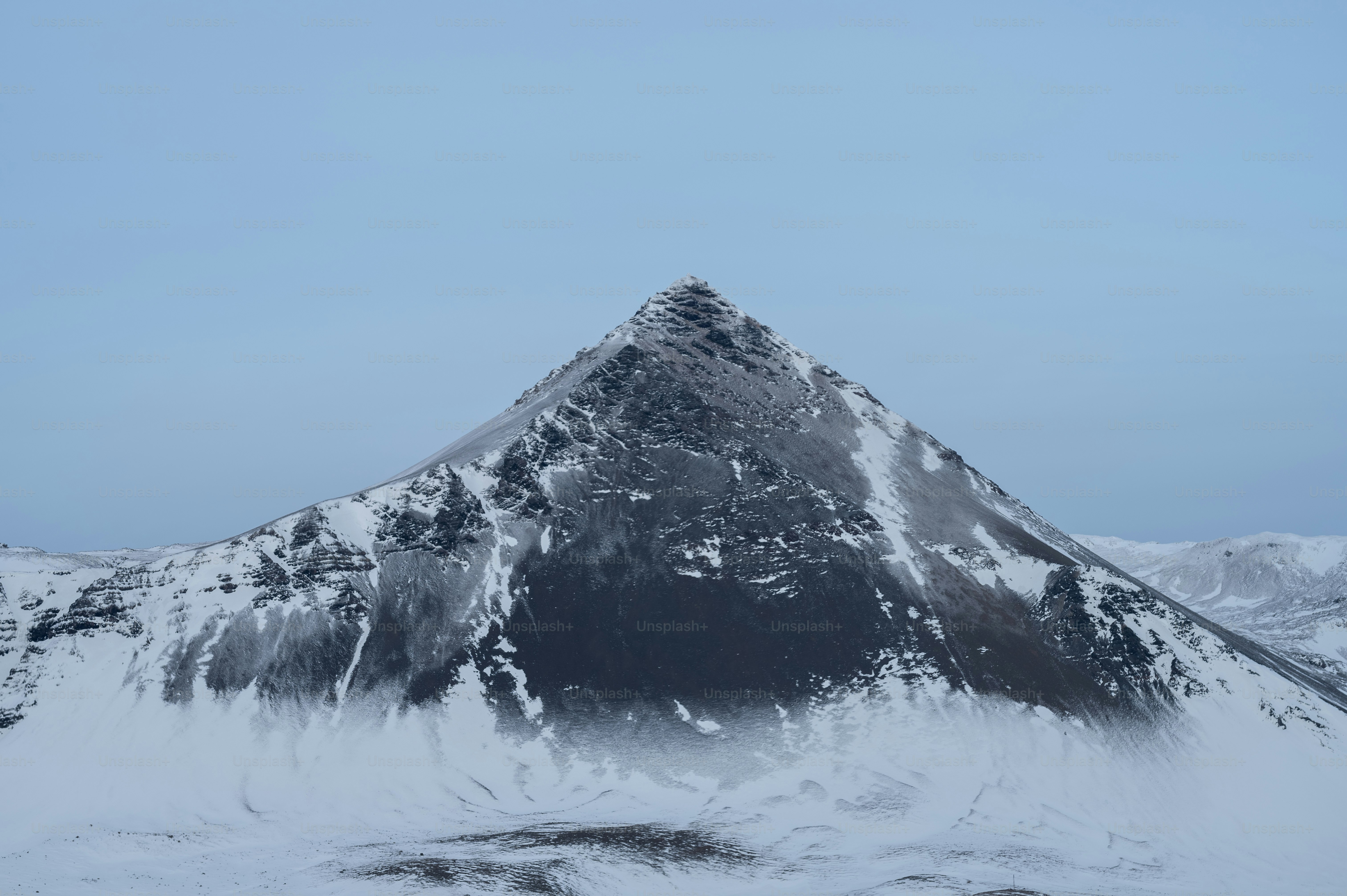 a snow covered mountain with a blue sky in the background