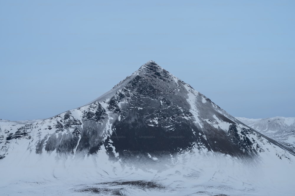 a snow covered mountain with a blue sky in the background