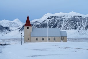 a church in the middle of a snowy field