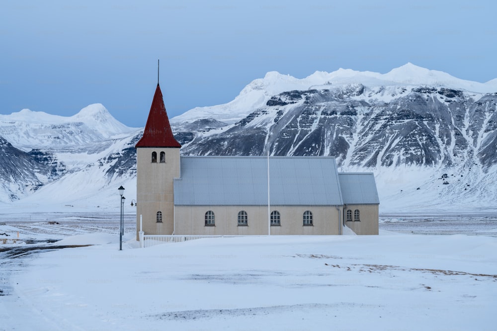 a church in the middle of a snowy field