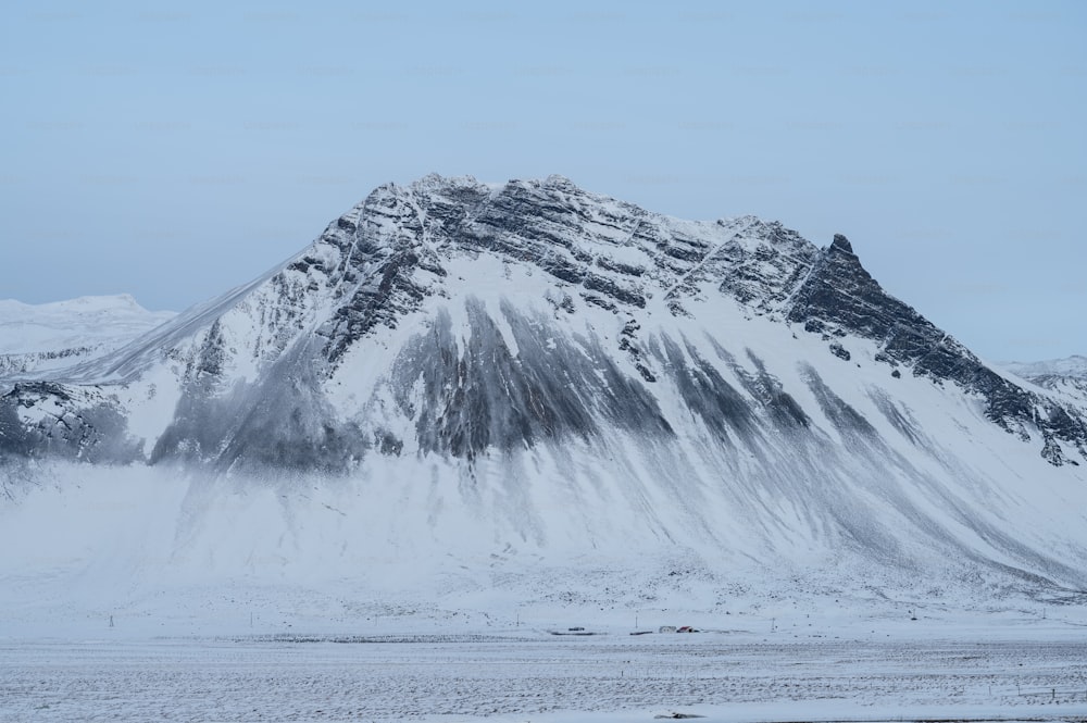 a large mountain covered in snow on a cloudy day