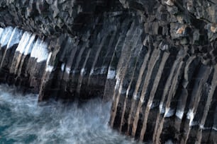 a large rock formation next to a body of water