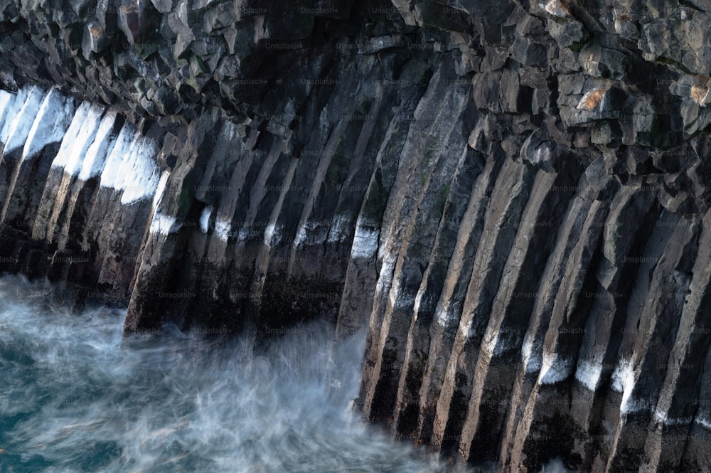 a large rock formation next to a body of water