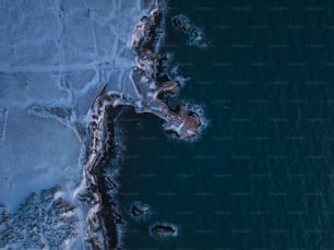 an aerial view of a body of water covered in snow