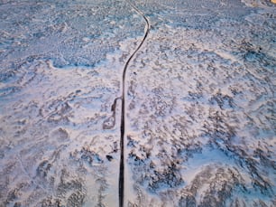 an aerial view of a road in the snow