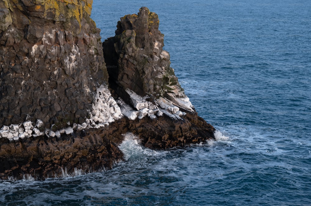 a rock outcropping in the middle of the ocean