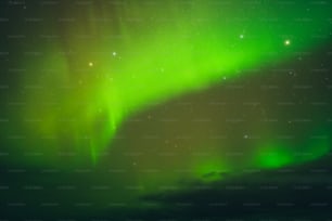 a bright green aurora bore is in the sky