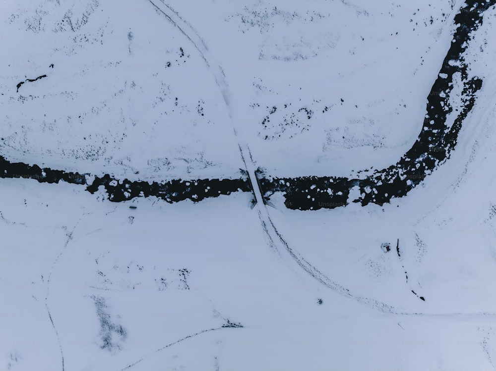 an aerial view of a road in the snow