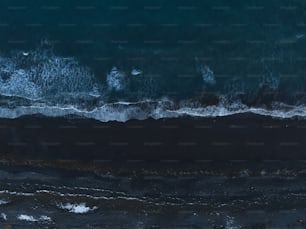 an aerial view of the ocean with waves