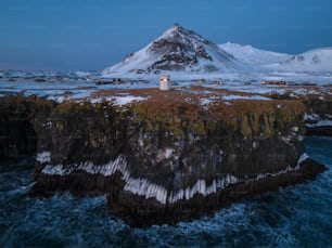 a lighthouse on an island in the middle of the ocean