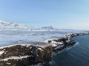 a large body of water surrounded by snow covered mountains