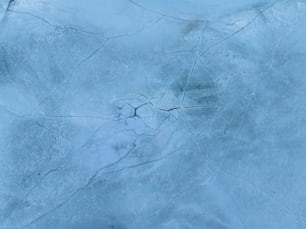 a snow covered ground with cracks in it