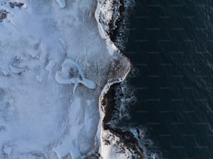 an aerial view of a beach covered in snow