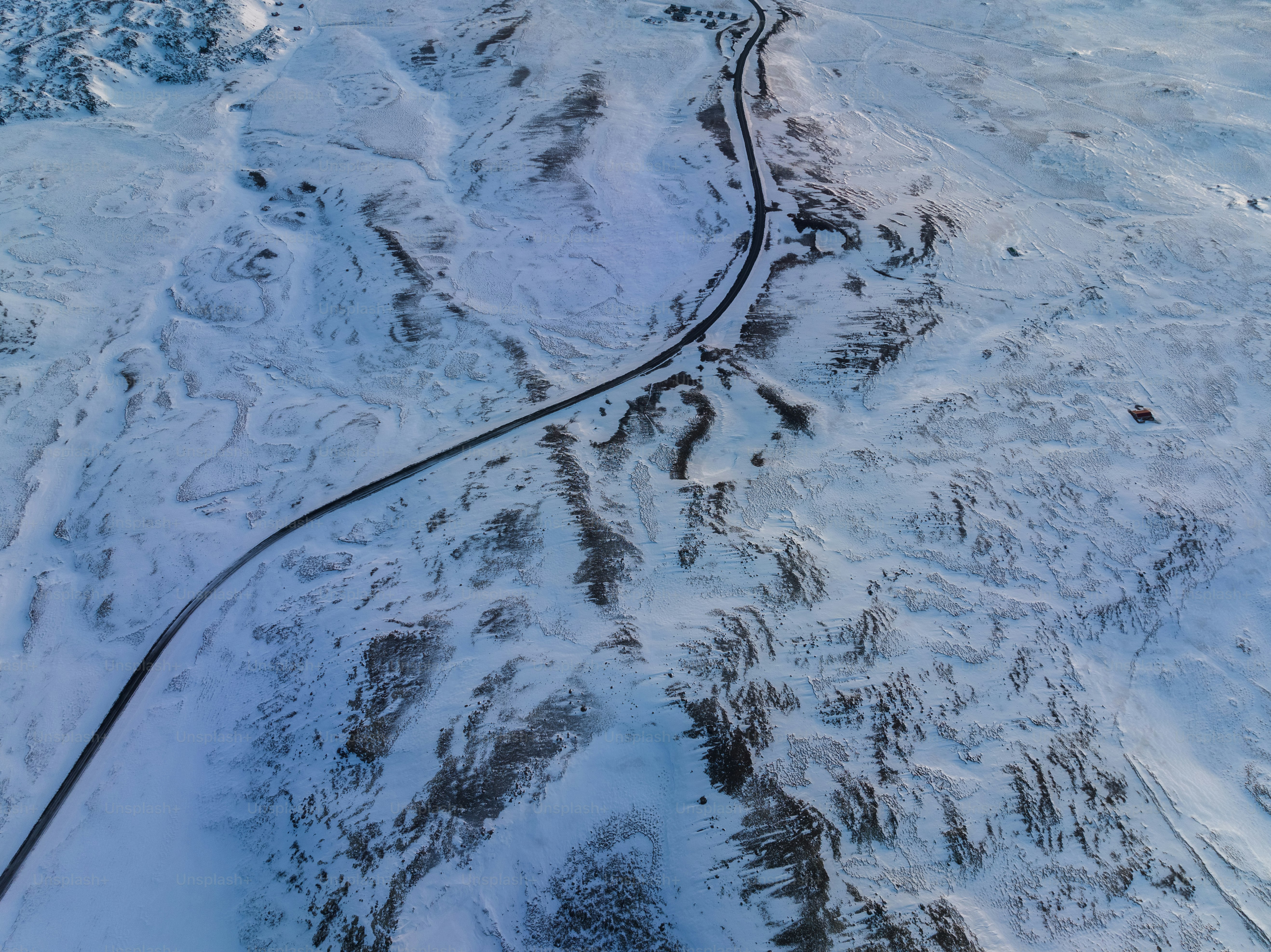 An aerial view of a snow covered mountain photo – Aerial view Image on ...