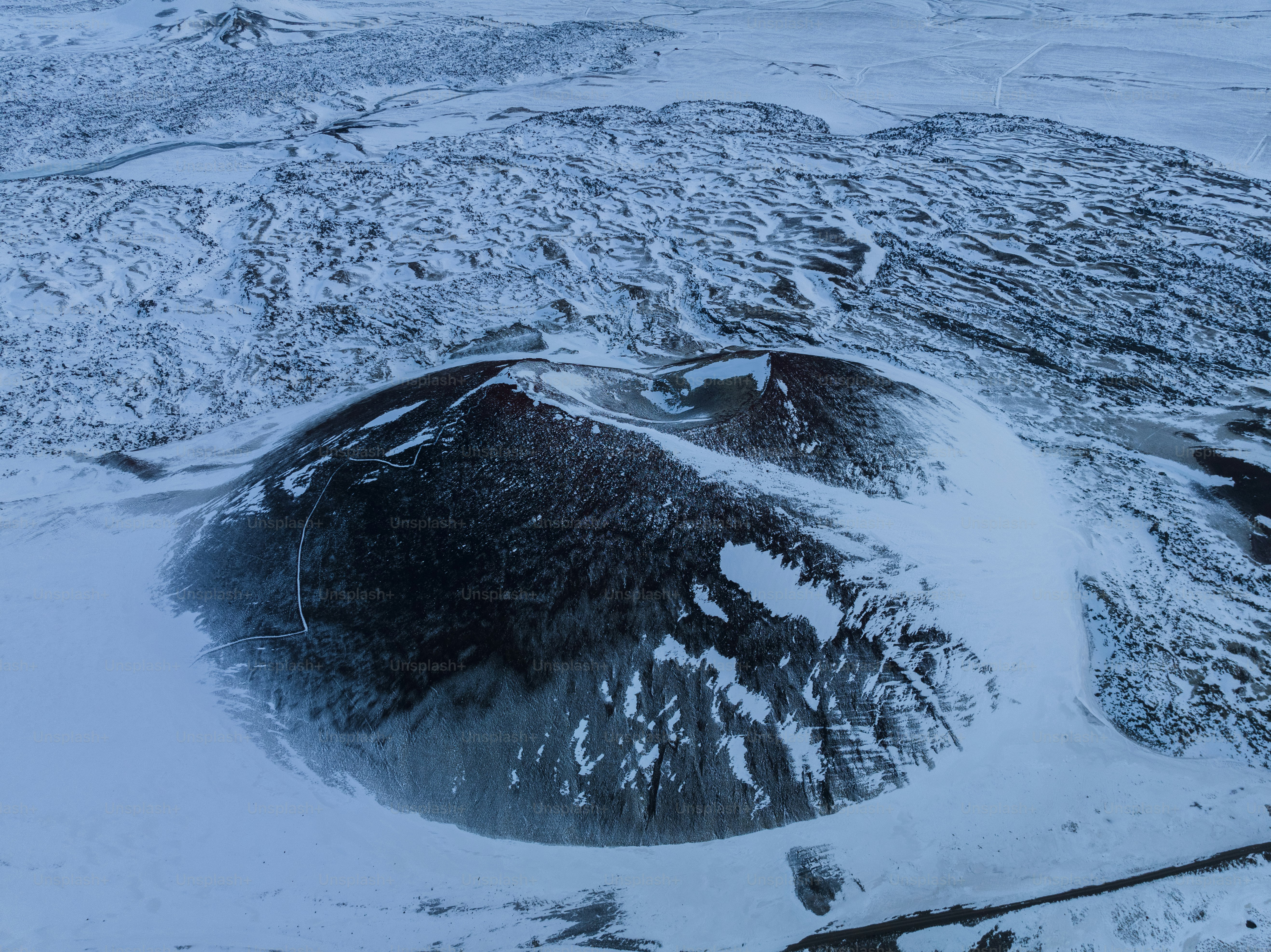 An aerial view of a snow covered mountain photo – Travel Image on Unsplash