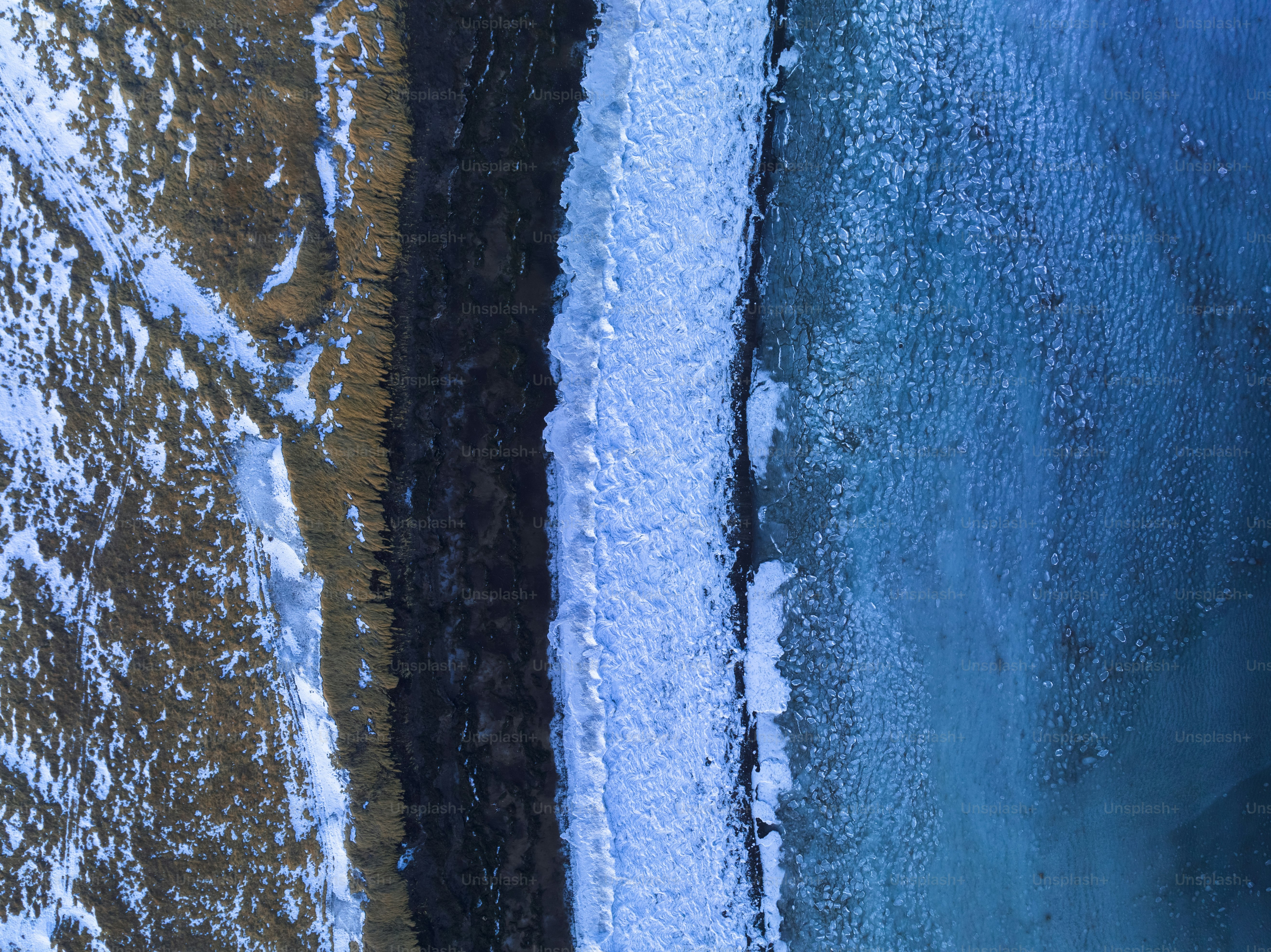 An aerial view of a black object in the snow photo – Outdoor Image on ...