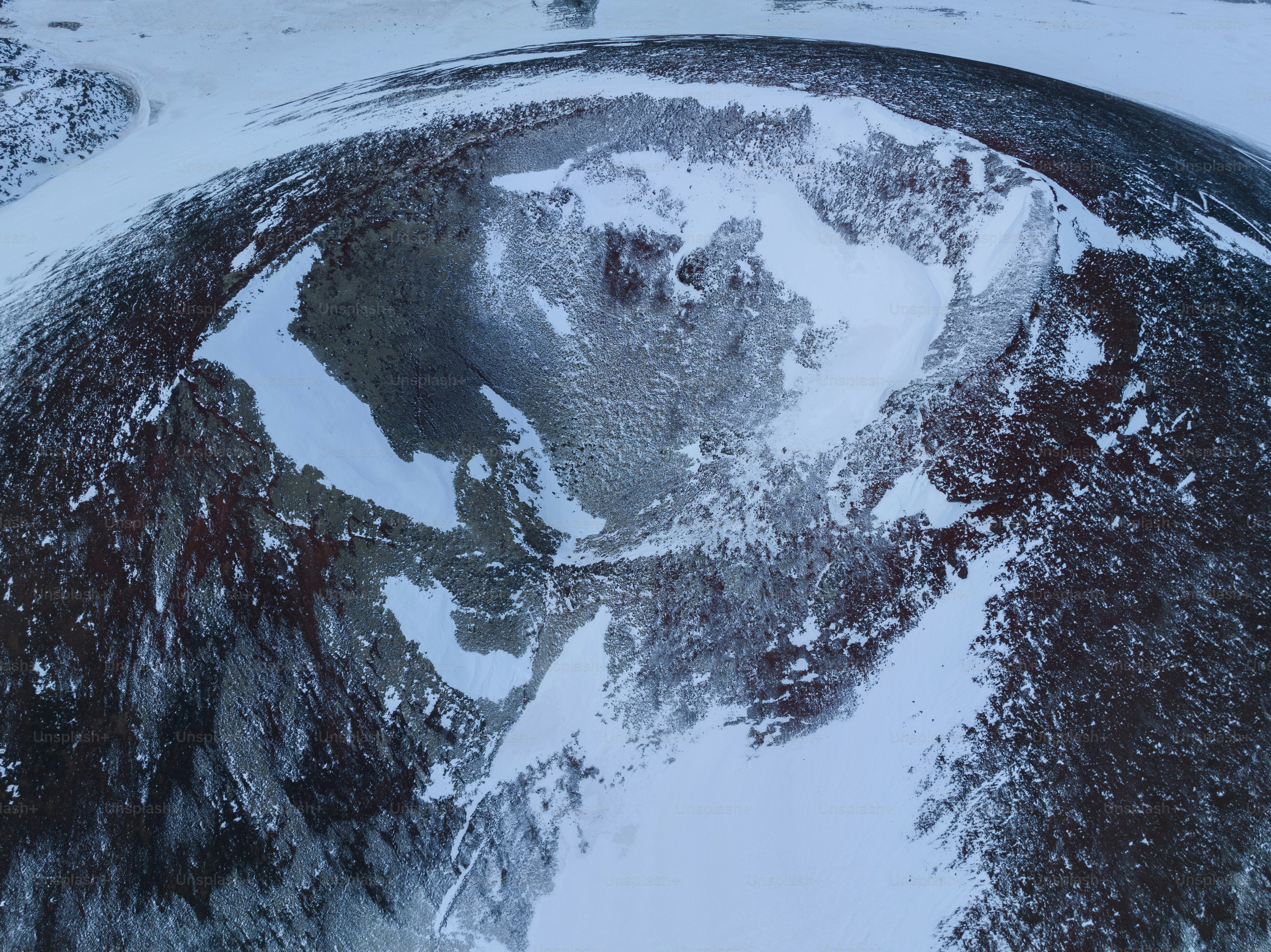 An aerial view of a snow covered mountain photo – Mountains Image on ...