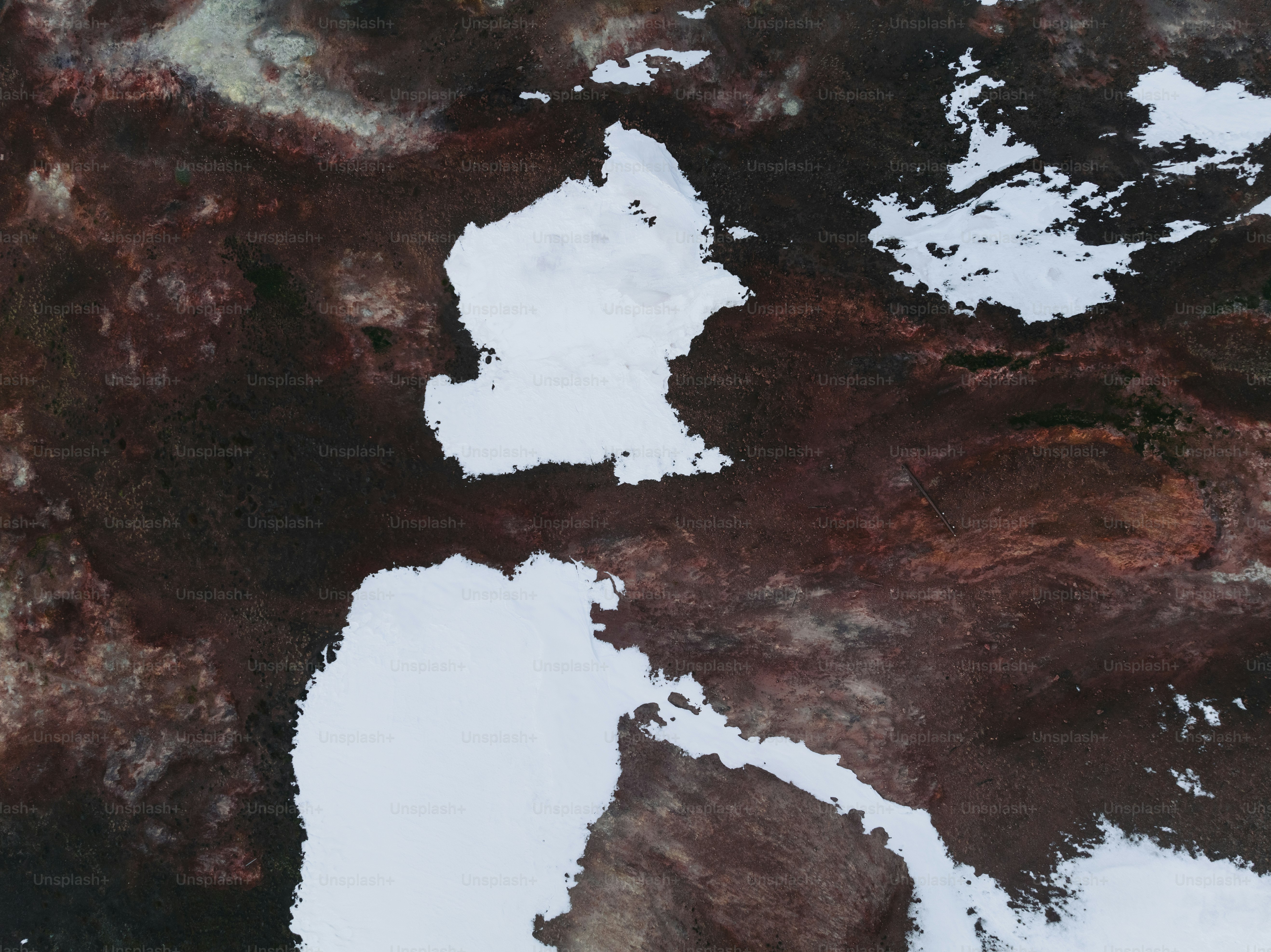 an aerial view of a snow covered area