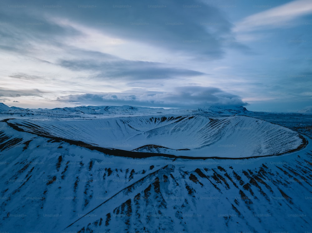 an aerial view of a snow covered mountain range