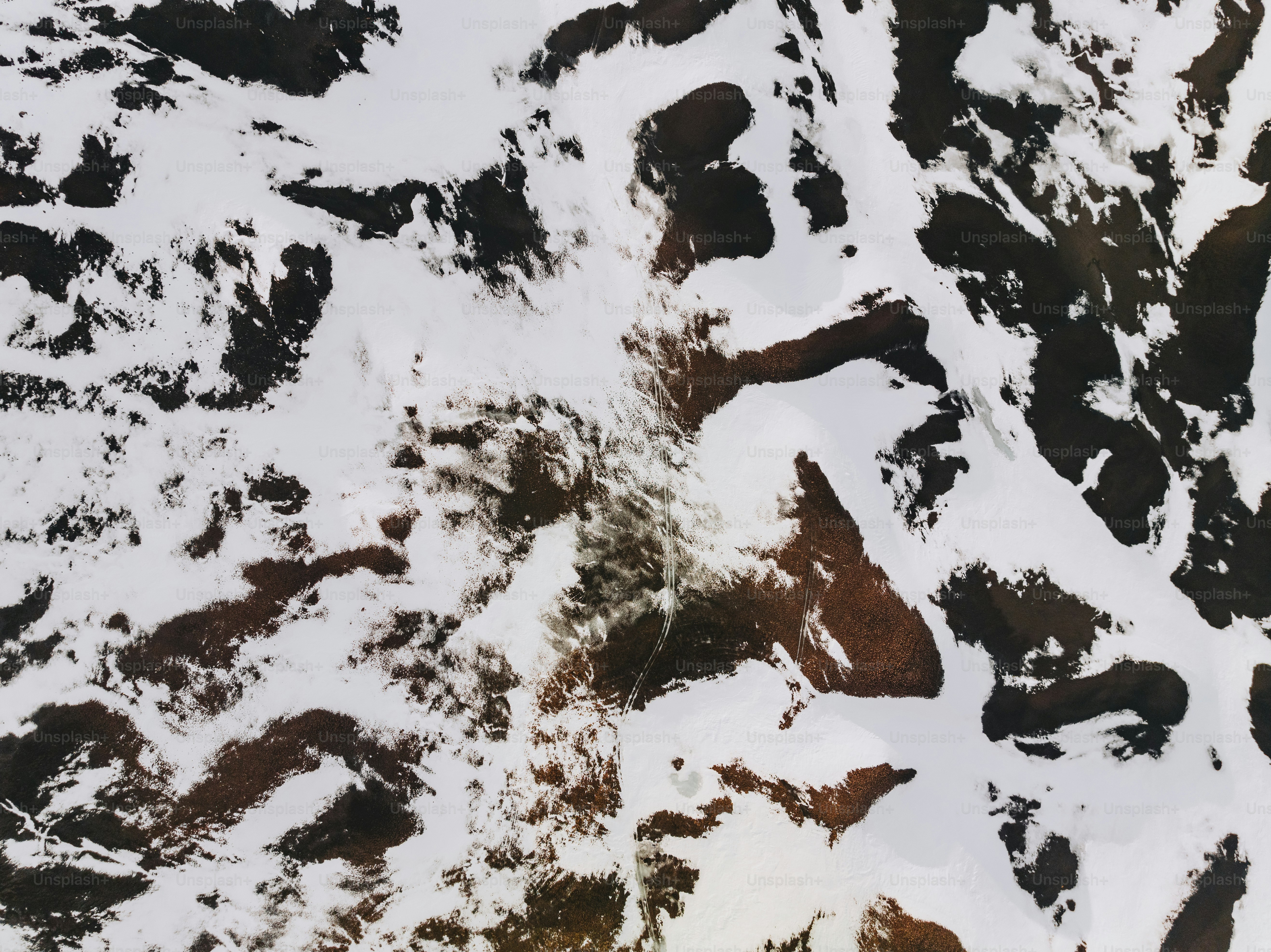 an aerial view of a snow covered mountain