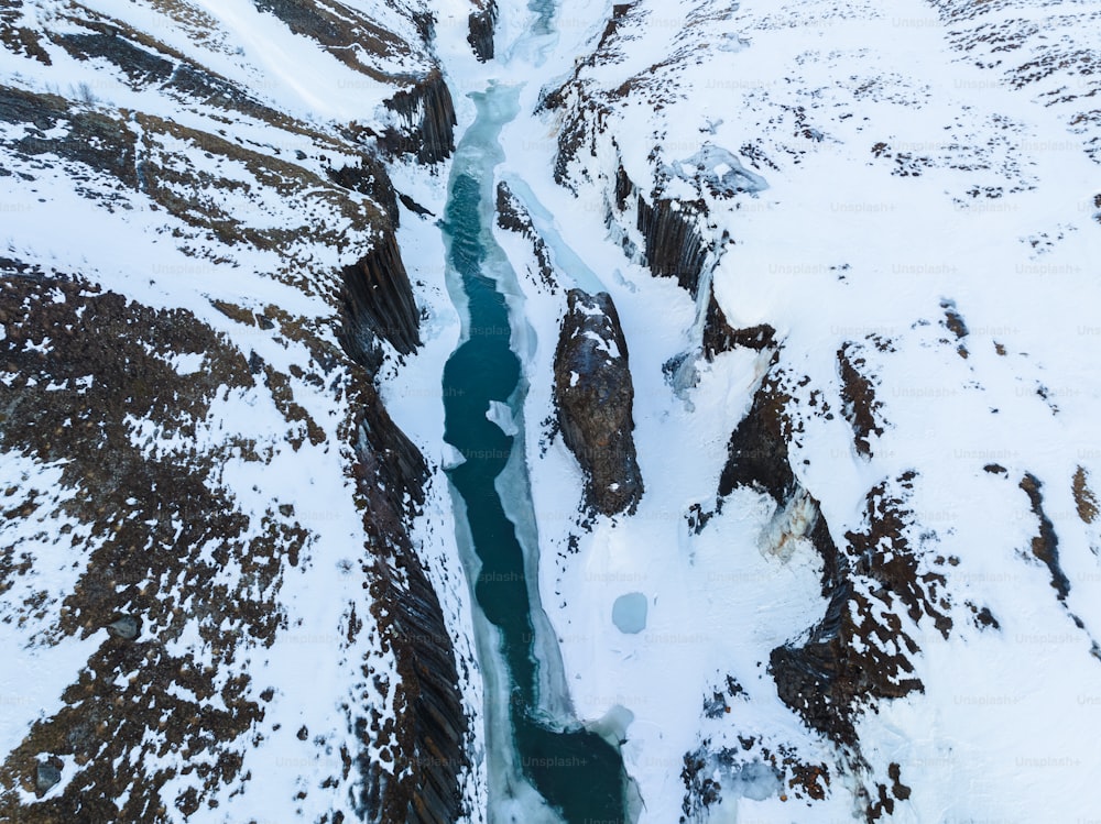 an aerial view of a river running through a snow covered landscape