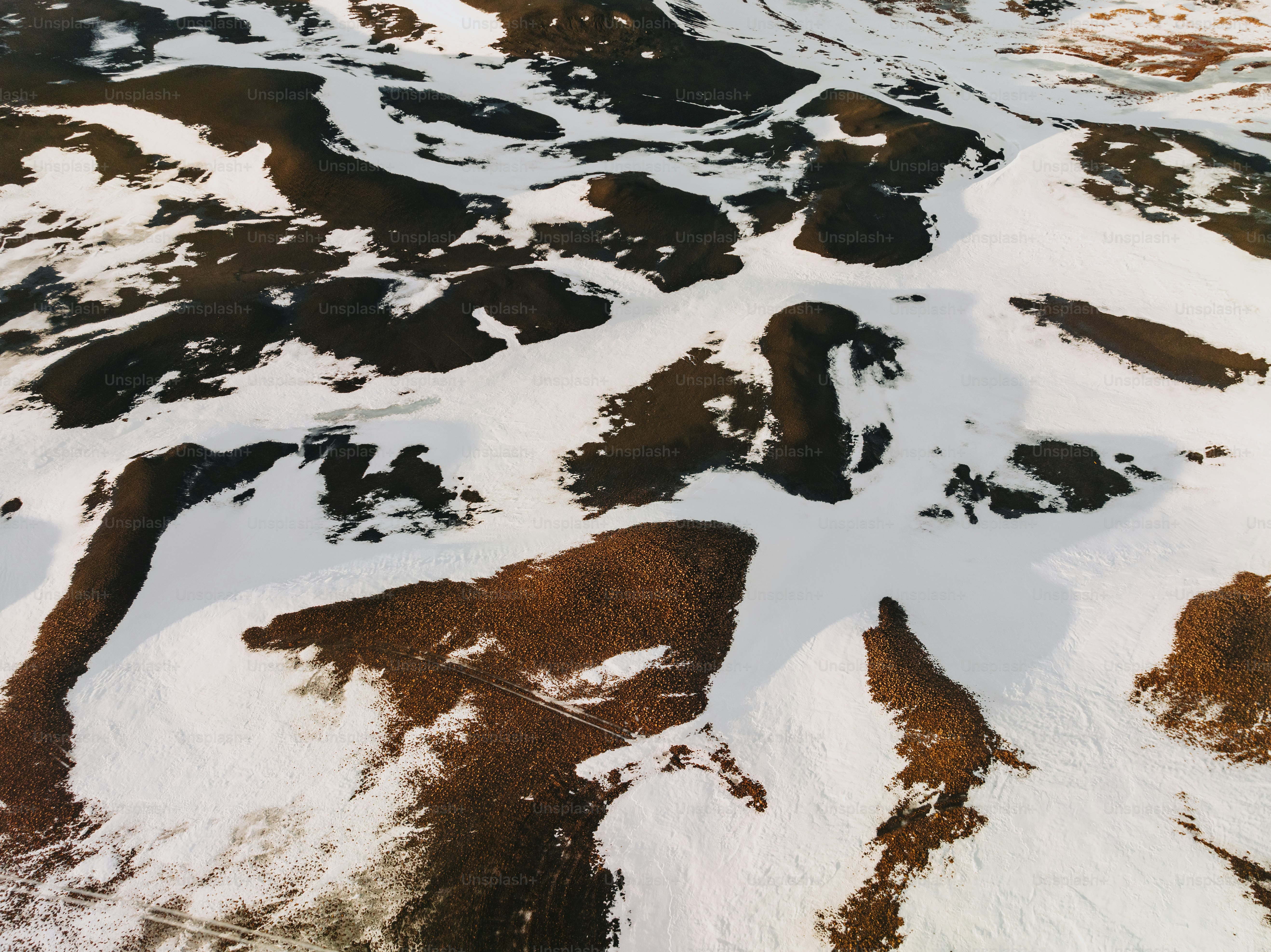 An aerial view of a snow covered mountain photo – Snow Image on Unsplash