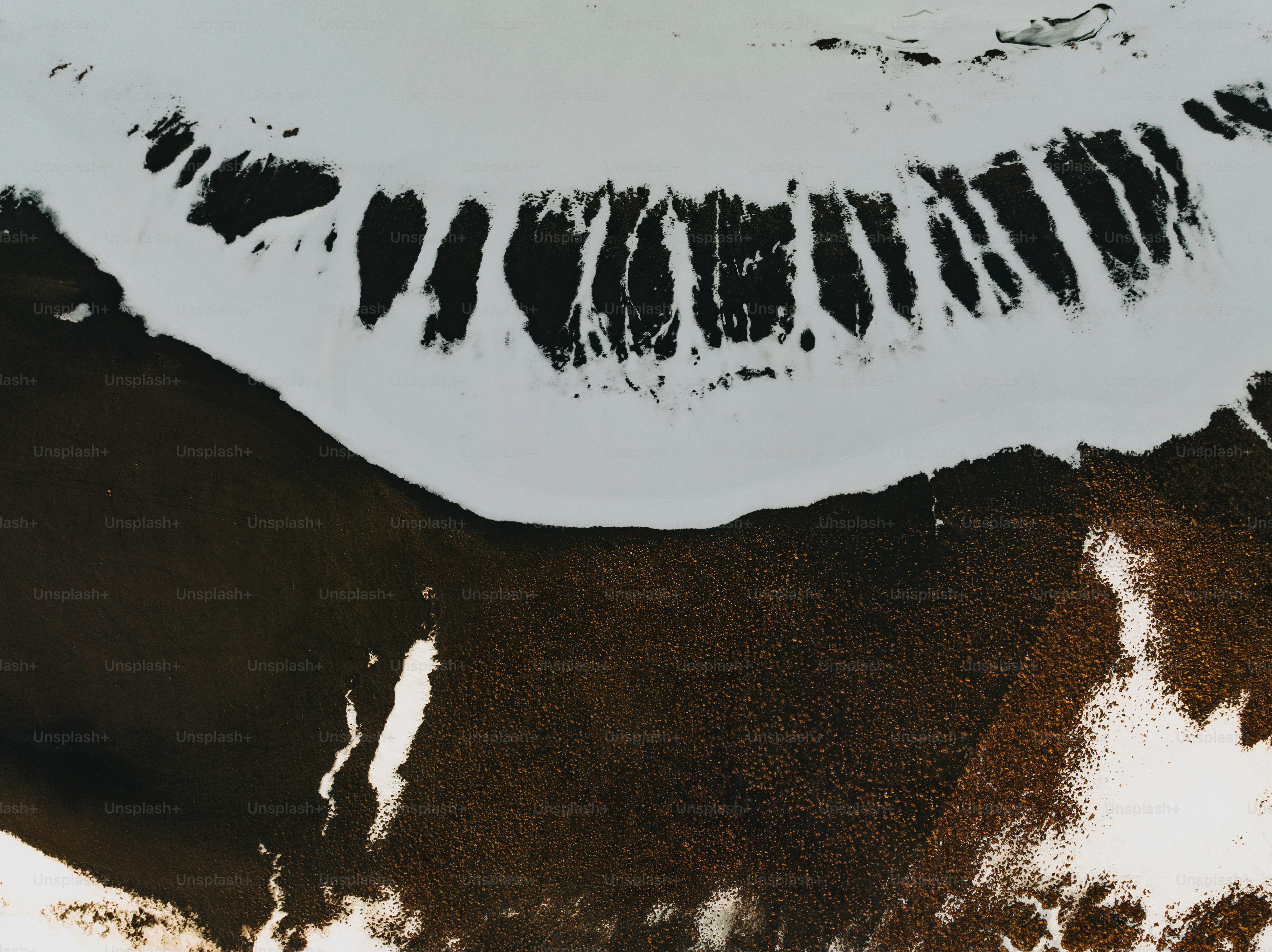an aerial view of a snow covered mountain