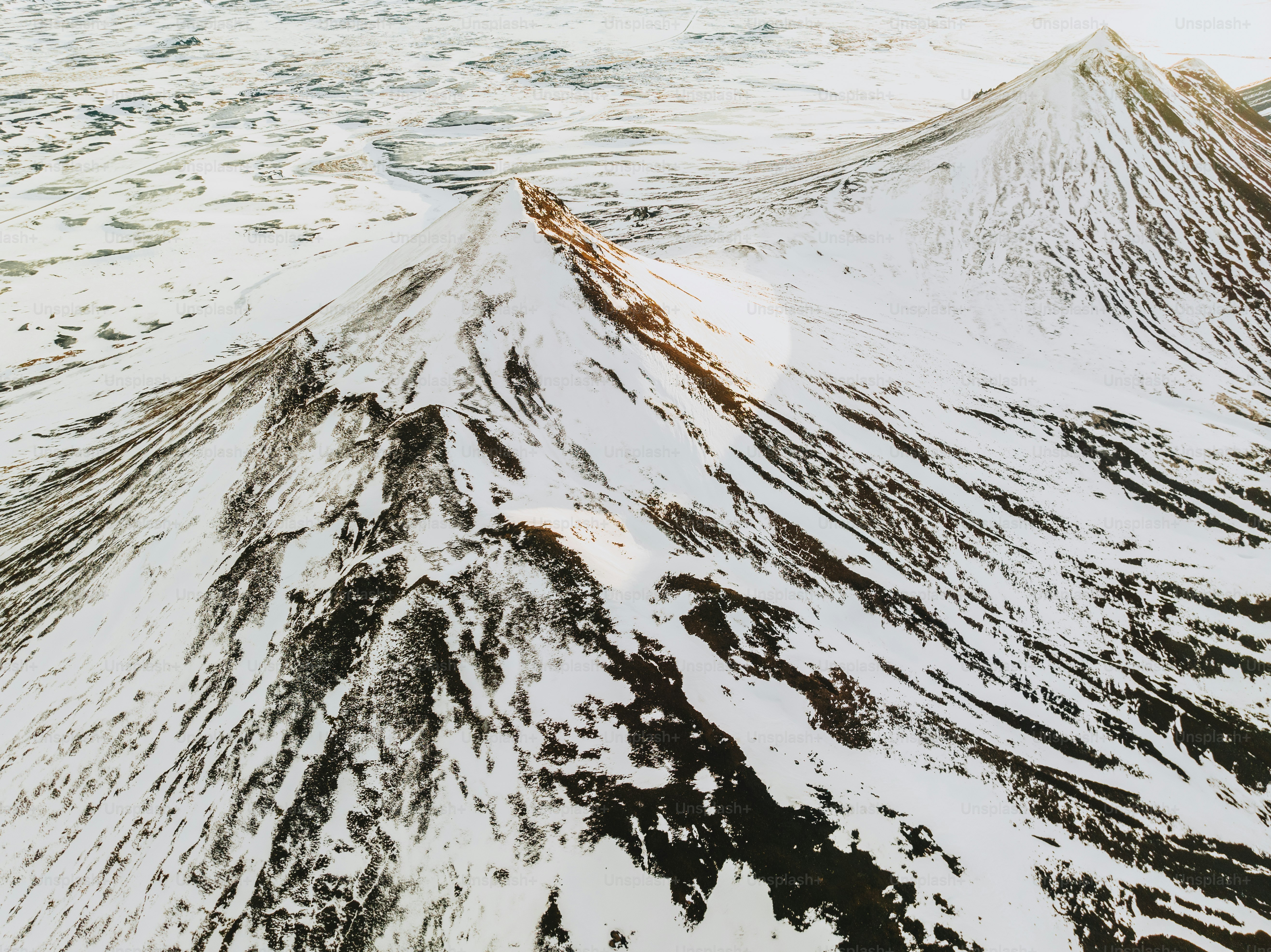 an aerial view of a snow covered mountain