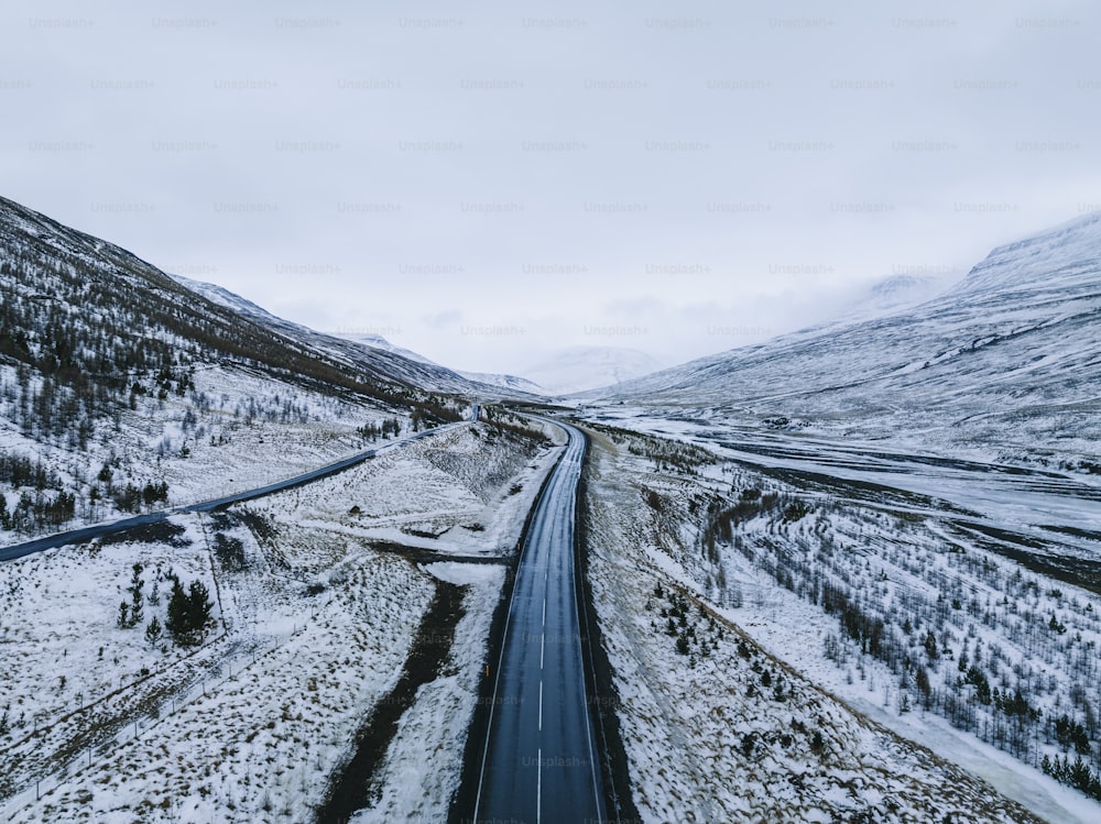 an aerial view of a road in the mountains