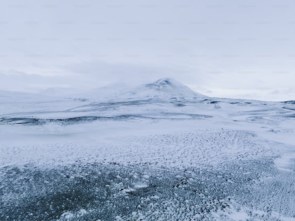 a mountain covered in snow with a sky background