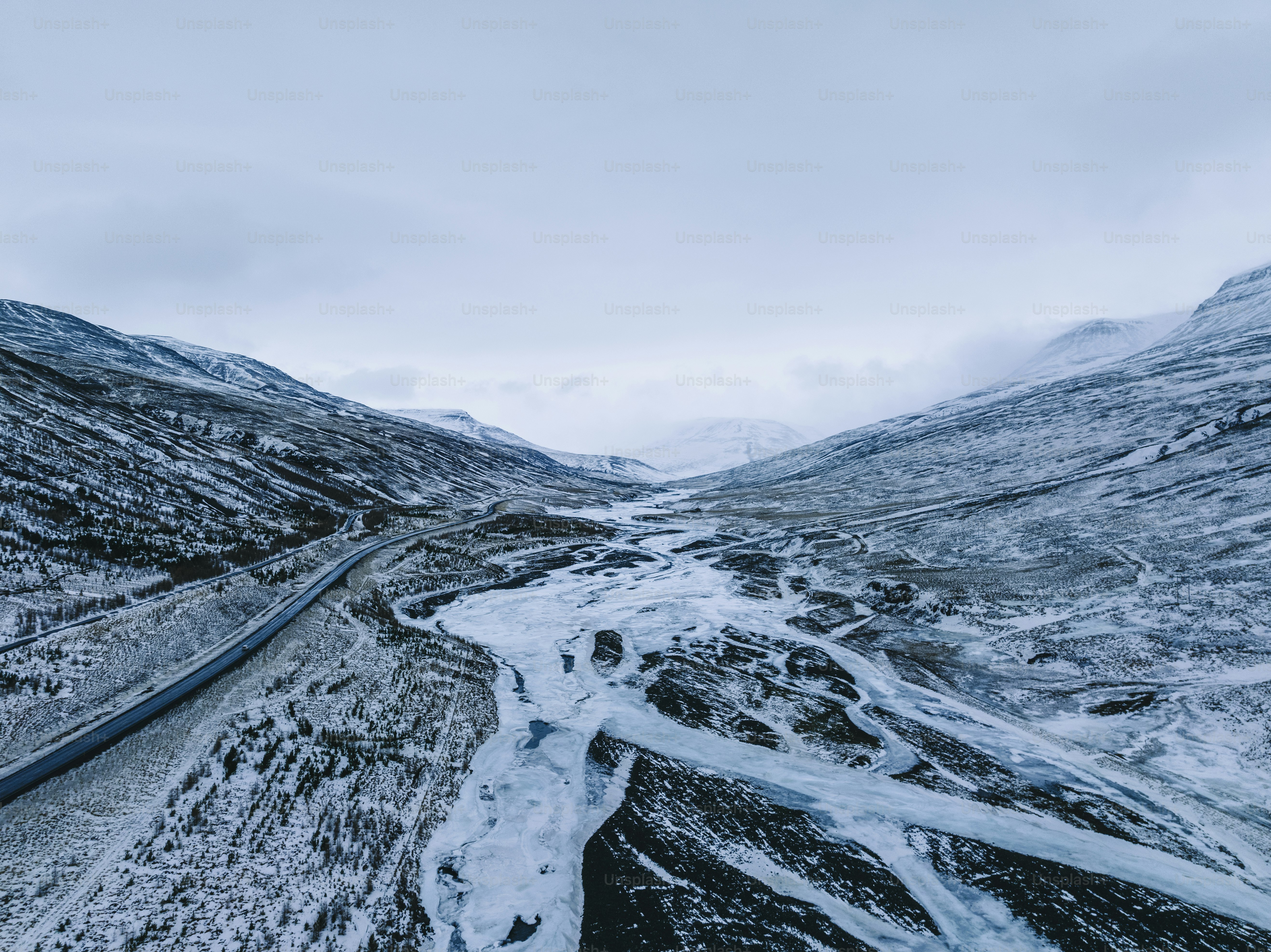 an aerial view of a winding road in the mountains