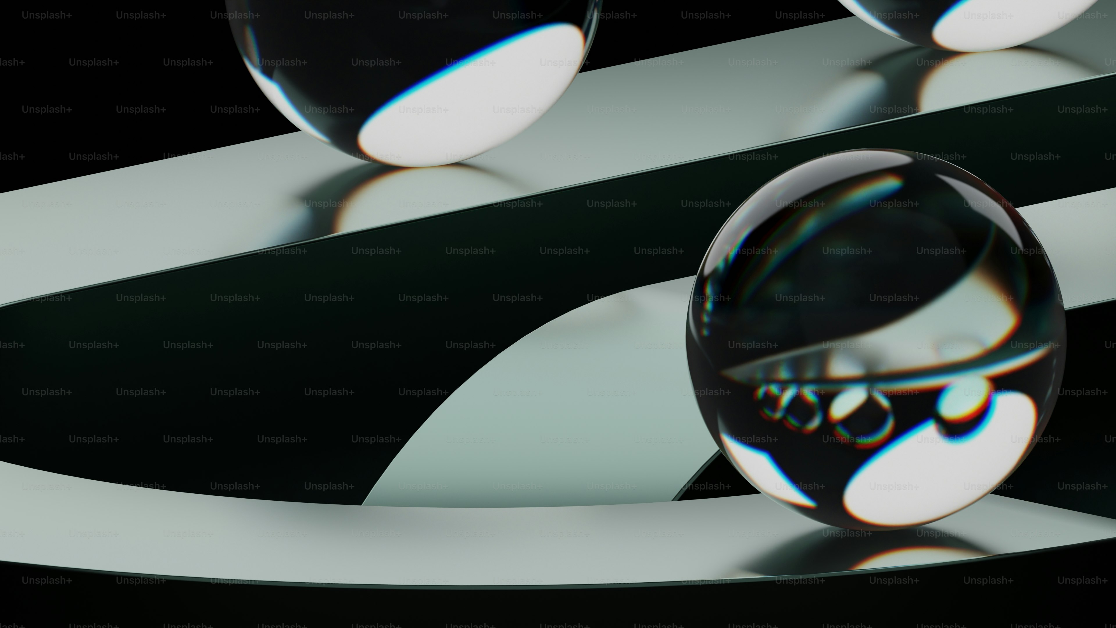 a black and white photo of three glass balls