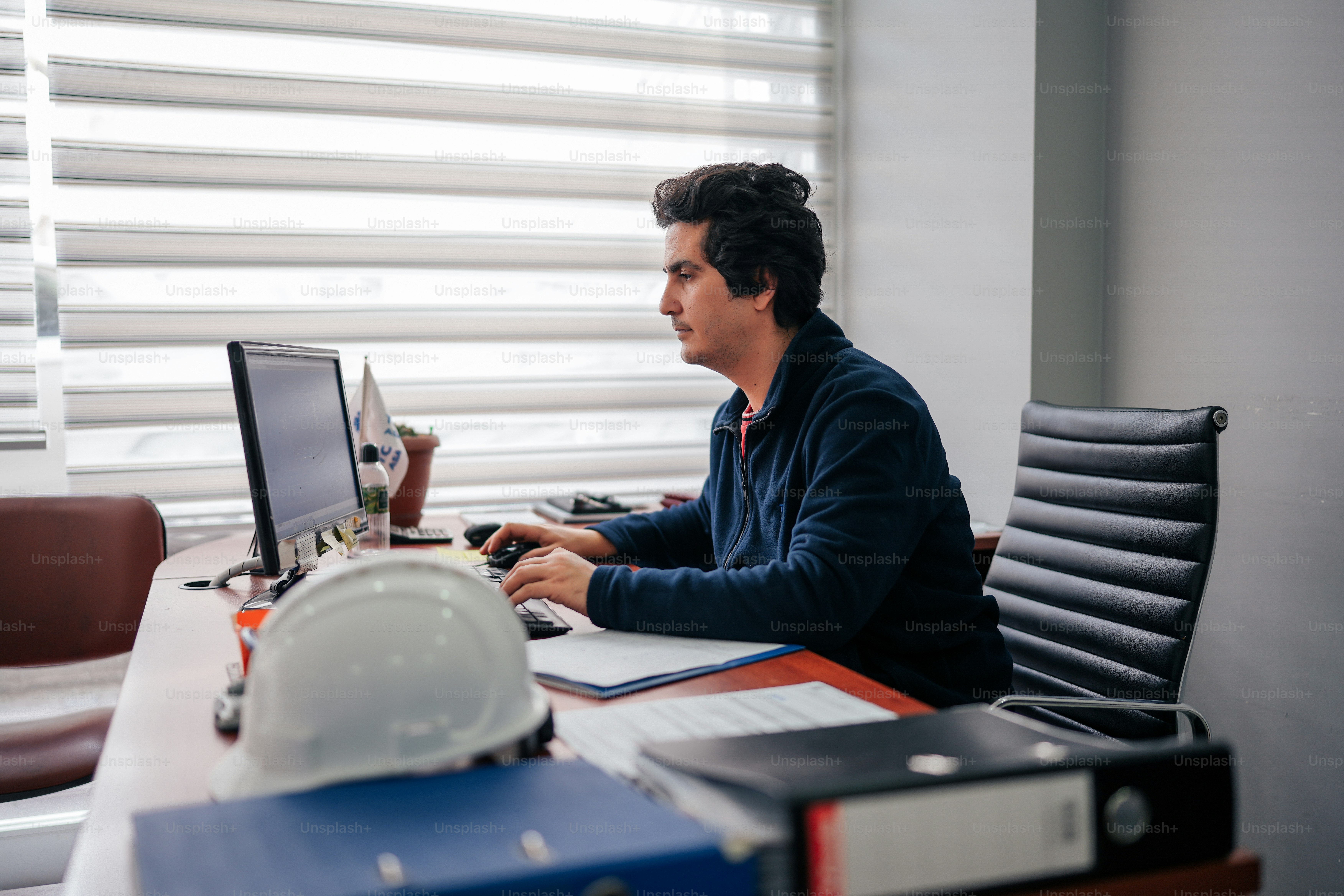 a man sitting at a desk in front of a computer